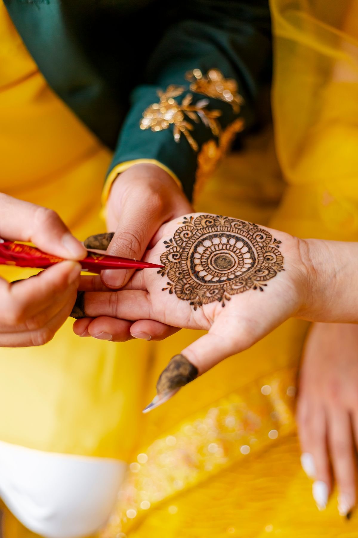 Bride with intricate bridal mehendi design on both hands